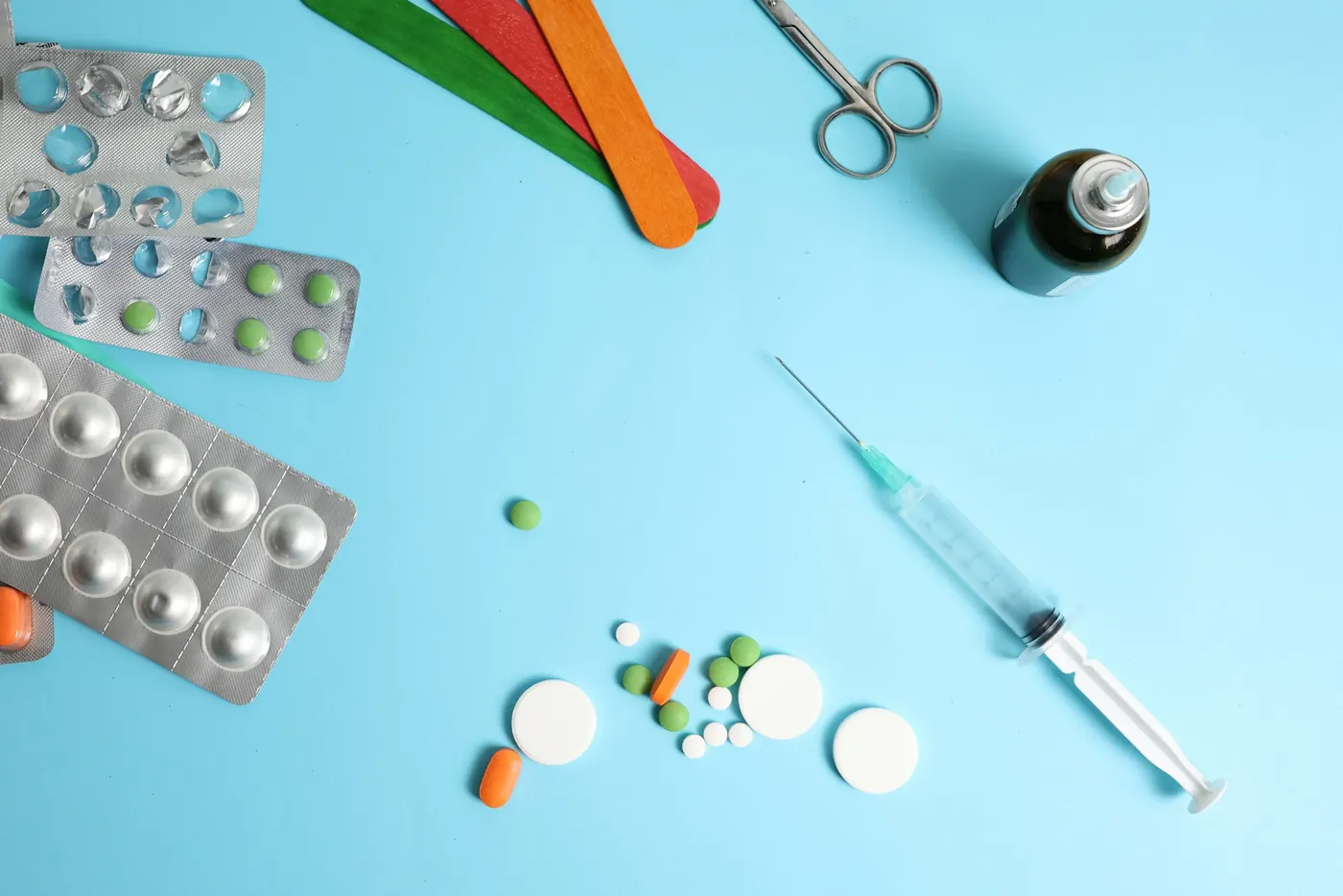 Medical supplies laid out on a blue surface