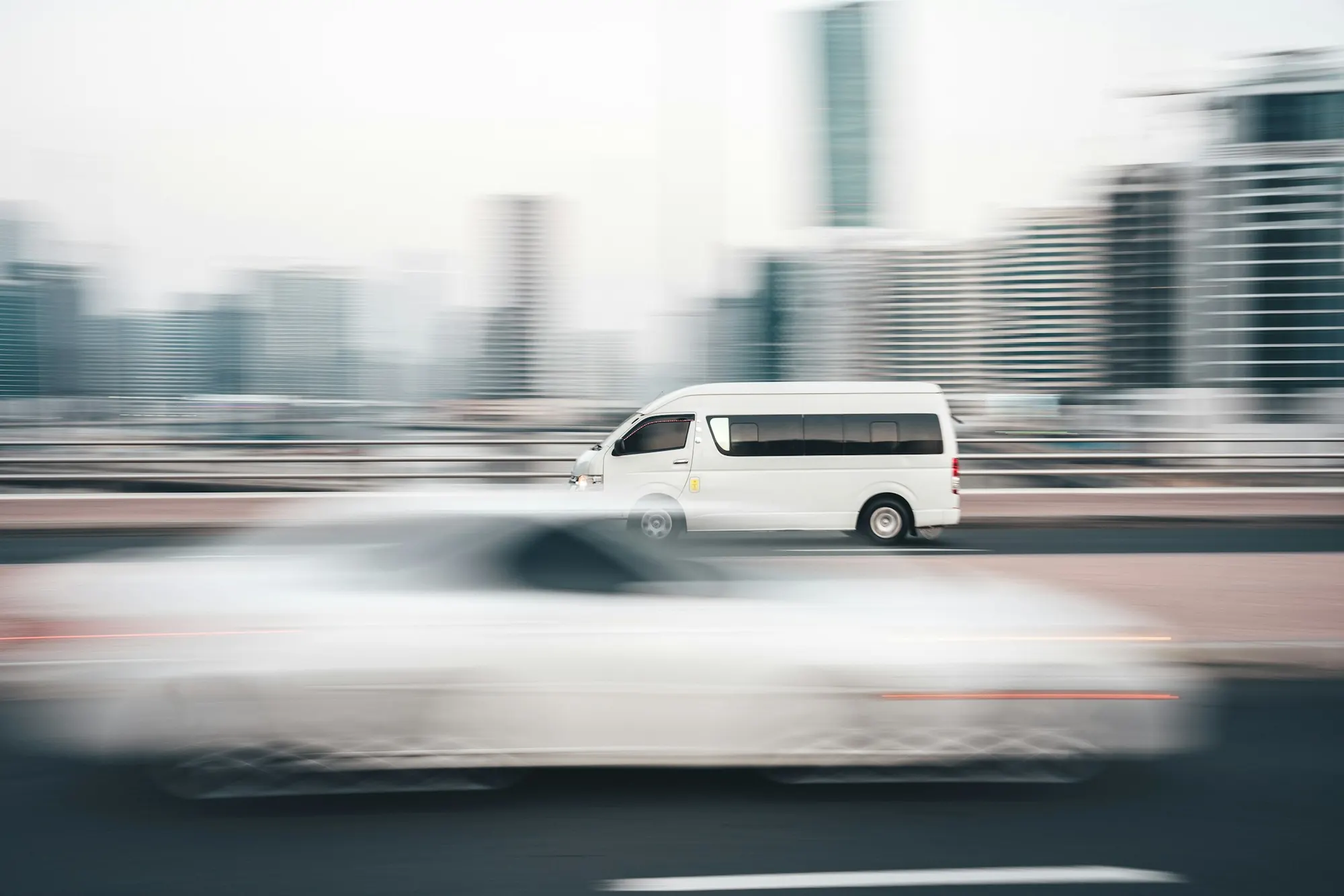 White delivery van driving through the city